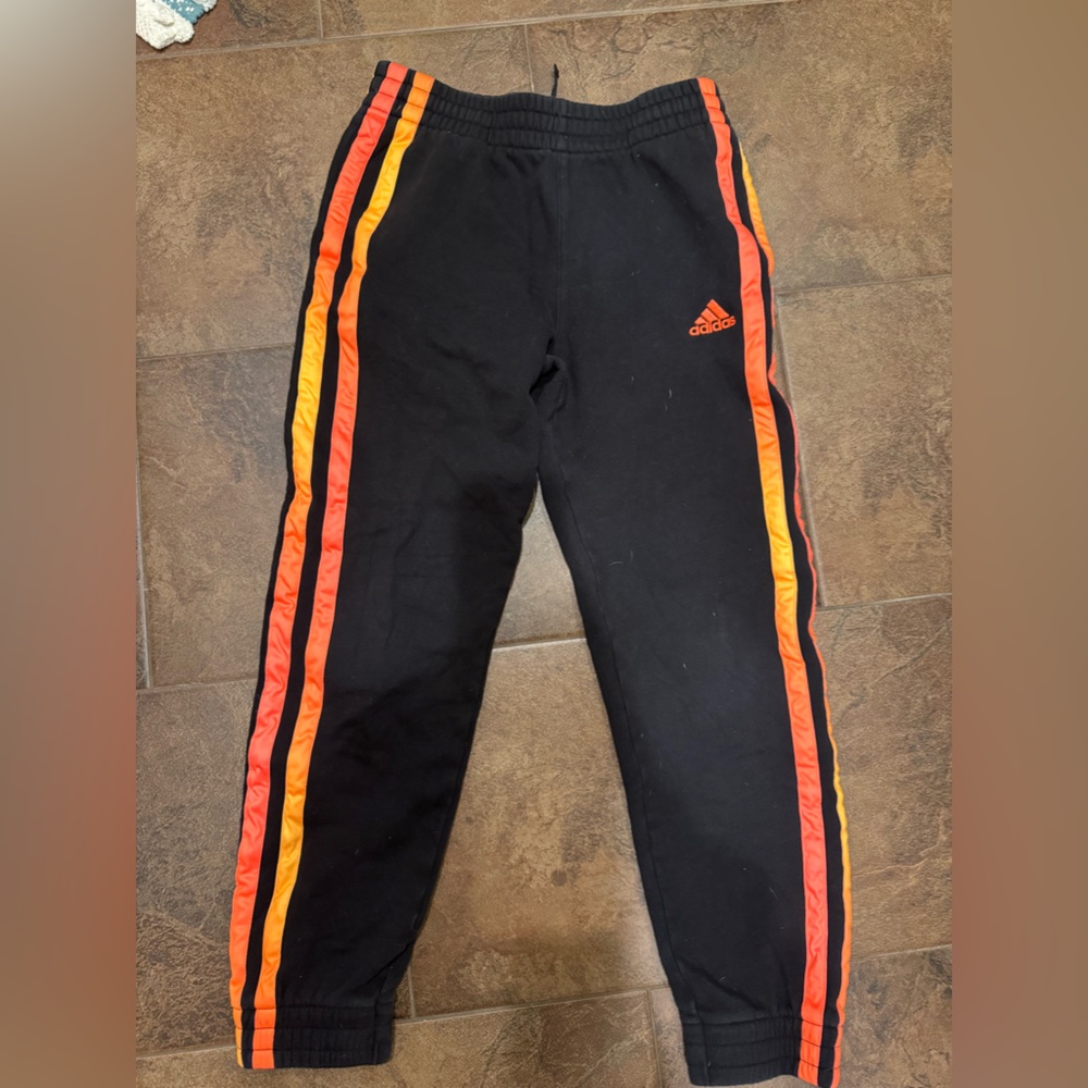 Black Adidas sweatpants with Red and Orange Accents